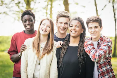 Multiethnic group of teenagers outdoors and benefitting from superior pediatric dental services at Lisa Siddall DDS in Lake Leelanau, MI.