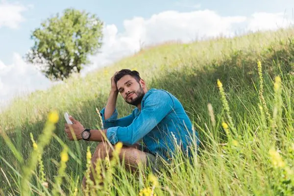 Image of man sitting on a hill.