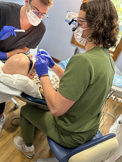 Dr. Lisa Siddall, DDS performing emergency dentistry procedure on a patient